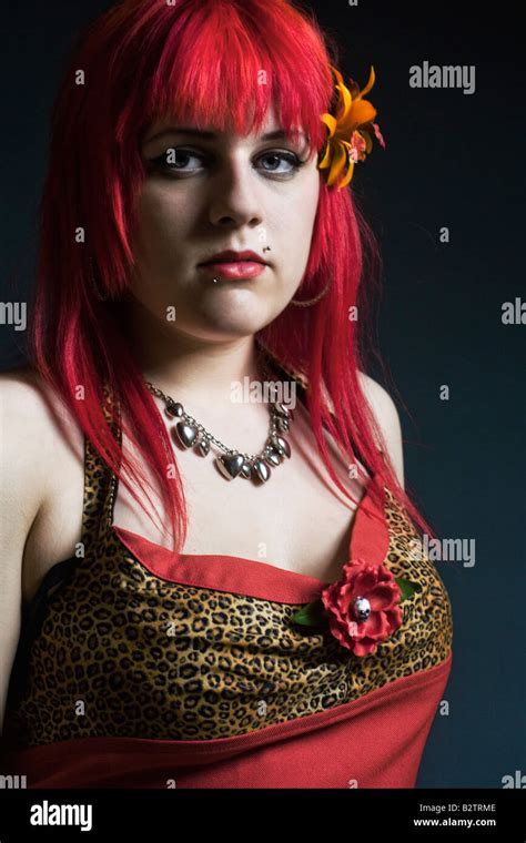 Headshot portrait of a young goth girl with dyed red hair Stock Photo - Alamy