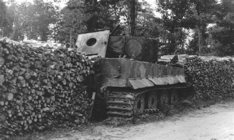 Knocked out Tiger I tank used as a filer in a woodpile wall. Either France or Italy. 1944. : r ...