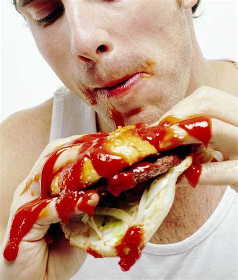 Man Eating Burger Photograph by Jason Kelvin/science Photo Libray