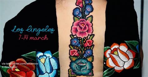 Floral mexican embroidery tattoo located on the back.