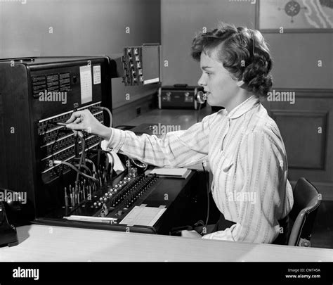 1950s WOMAN OFFICE TELEPHONE SWITCHBOARD RECEPTIONIST OPERATOR WEARING HEADSET ANSWERING ...