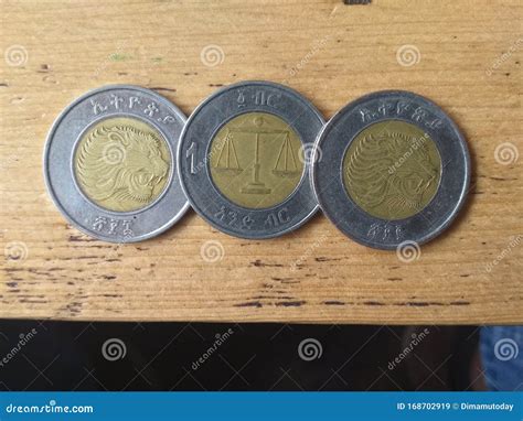 Bimetallic Coins - a Recent Issue of 1 Birr of Ethiopia on a Wooden Table Editorial Stock Image ...