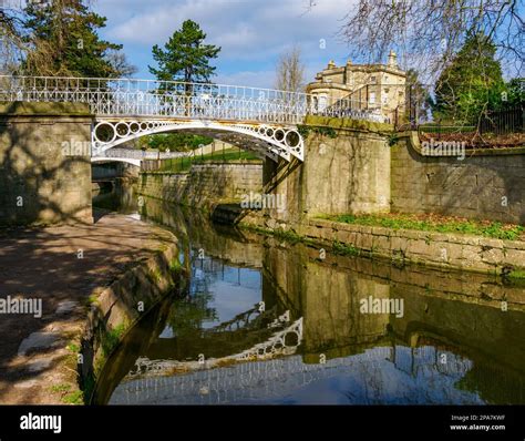 Ornate white painted cast iron bridge over the Kennet and Avon canal at ...