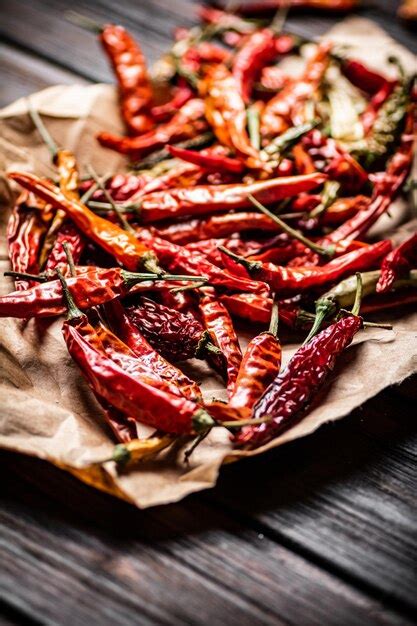 Premium Photo | Dried chili peppers on paper