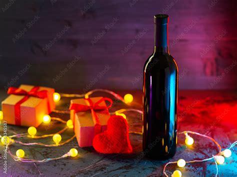 A romantic evening for Valentine's Day. A bottle of red wine and gifts on the table Stock Photo ...