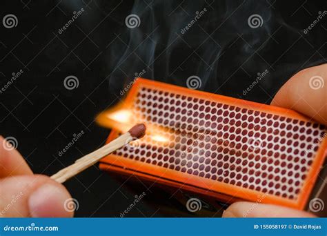 Man S Fingers Lighting A Match, Setting Fire On Friction. On A Black Background. Matches And ...