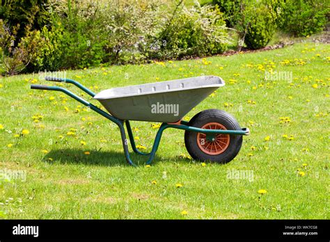 garden-wheelbarrow on green grass Stock Photo - Alamy