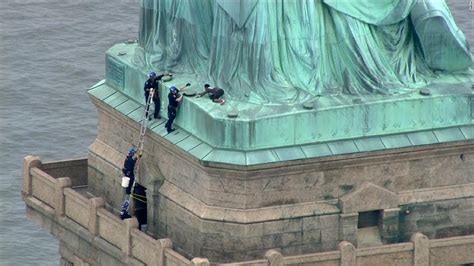 Woman climbs base of the Statue of Liberty - CNN Video