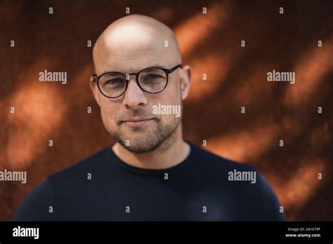 Portrait of bald man with beard wearing glasses Stock Photo - Alamy