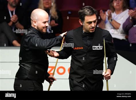 Ronnie O'Sullivan congratulates Luca Brecel (left) on day twelve of the ...