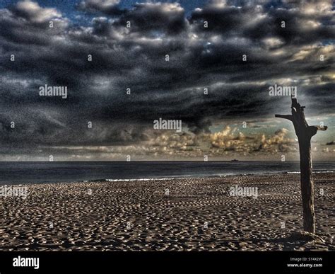 Beach with dark sky Stock Photo - Alamy