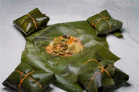 Top View of raw ingredients of the Nicaraguan nacatamal on banana leaves. Raw ingredients for ...