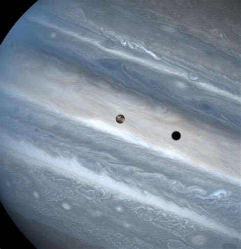 The volcanic moon Io and its shadow cast on Jupiter. © John Spencer ...