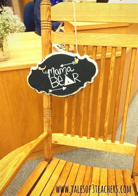 a wooden chair with a chalkboard sign hanging from it's back and side