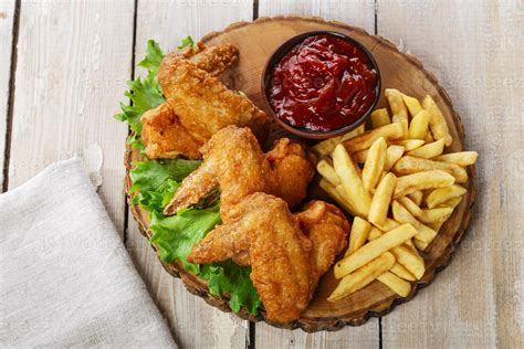 Fried chicken wings with sauce and French fries 722527 Stock Photo at ...