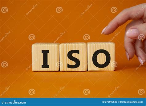 ISO Standards Quality Control Symbol. Concept Word ISO on Wooden Cubes. Businessman Hand ...