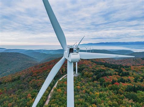 Close-up on the propellers of a wind turbine during a misty morning and ...