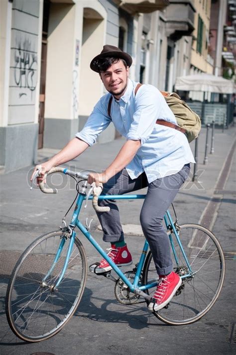 Hipster young man on bike in the city | Stock Photo | Colourbox