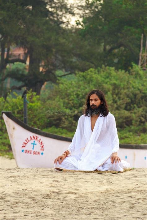 GOA, INDIA - APR. 24, 2014: Man Dressed in White Practices Yoga in Arambol, Goa, India on APR ...