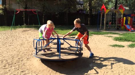 Spinning carousel - manually powered merry-go-round on a playground in ...