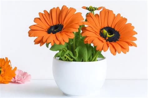 Premium AI Image | Orange flowers in a white vase