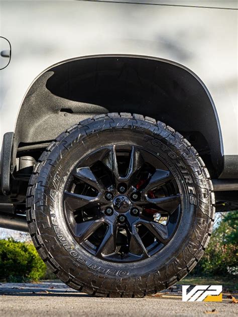 Straight on photo of off-road wheels on a white Chevy Silverado. Silverado High Country, Off ...