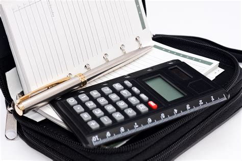 Calculator, pen and agenda in black organizer case | Flickr