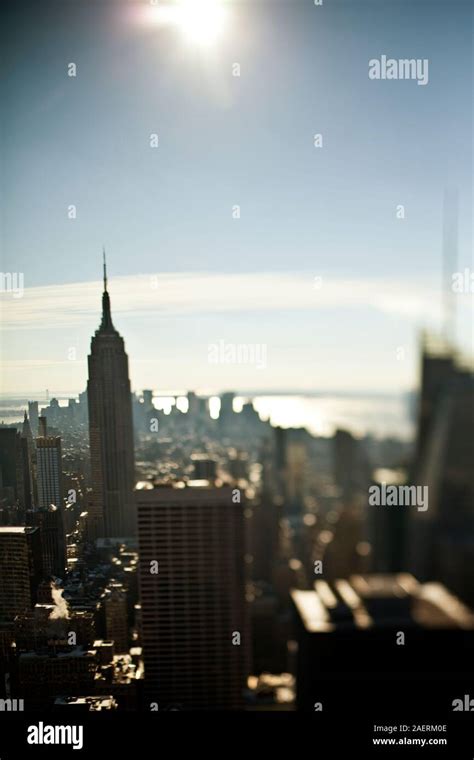 Cityscape with the Empire State Building under a bright sun, New York ...