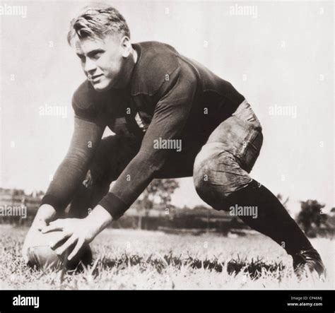 Future US President Gerald Ford centers a football during practice at the University of Michigan ...