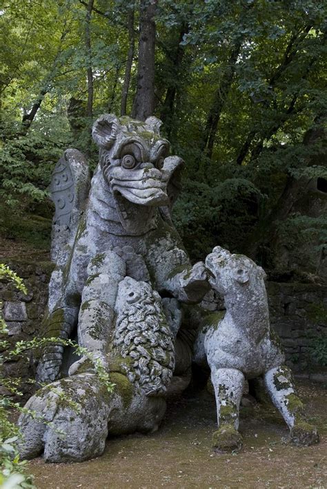 two statues in the shape of animals sitting next to each other on a ...