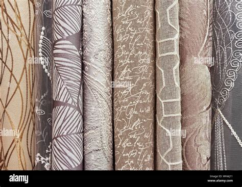 Samples of curtains in beige-brown palette. Background and texture of beige fabric for curtains ...