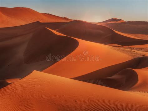 Sunrise Casting Shadows Over the Red Sand Dunes of the Namib Desert, Namibia. Stock Photo ...