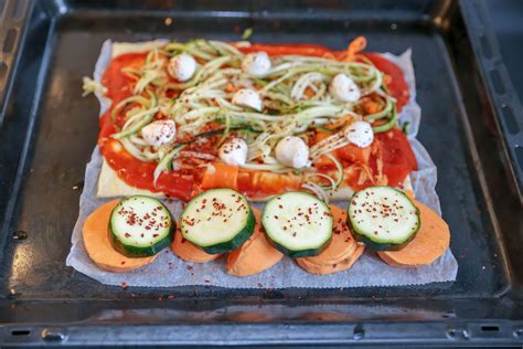 Half peeled and cut sweet potatoes on a kitchen table - Creative ...