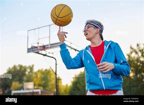 caucasian teenager boy perform tricks with a basketball on the sports ground. outdoors Stock ...