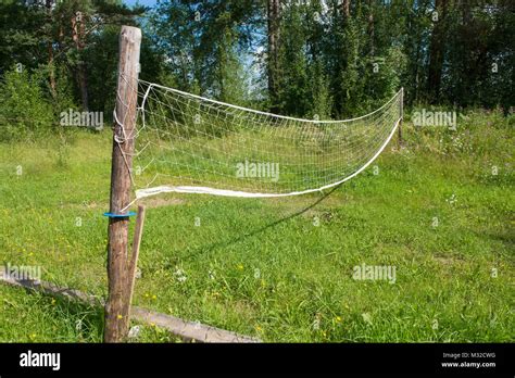 Village volleyball field with overgrown grass and sagging grid Stock ...