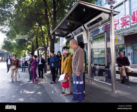 People waiting at bus stop in Shanghai, China Stock Photo - Alamy