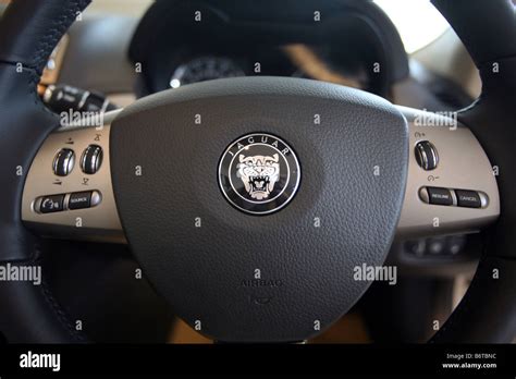 Jaguar badge on a car steering wheel Stock Photo - Alamy