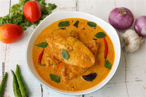 Kerala fish curry coconut milk gravy , cooking spicy Goan fish curry ...