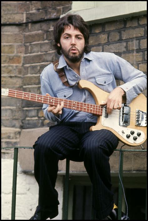 Paul McCartney - Paul playing guitar at home in London....