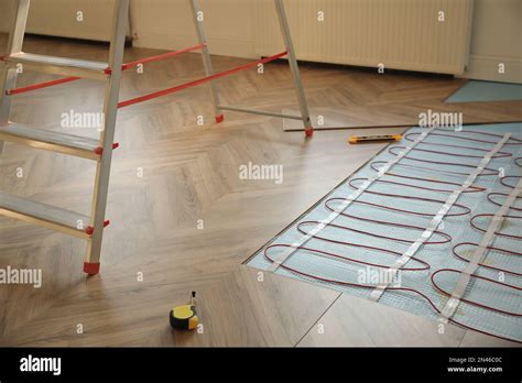 Installation of electric underfloor heating system indoors Stock Photo ...