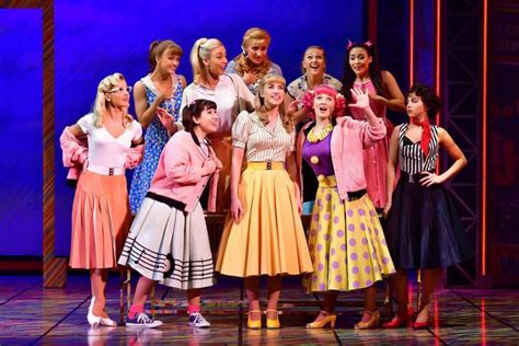 a group of women standing next to each other on a stage