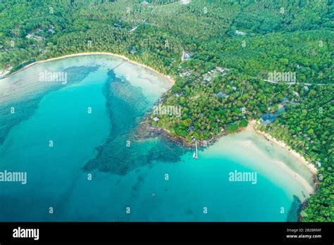 Exotic idyllic sea island with green tree forest aerial view Stock Photo - Alamy