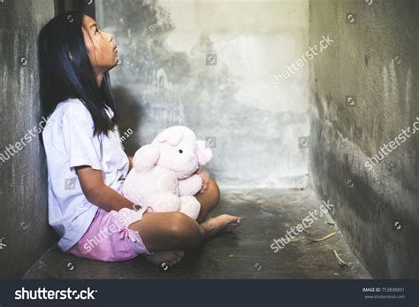 Sad Little Girl Sitting Against Wall Stock Photo (Edit Now) 753898891