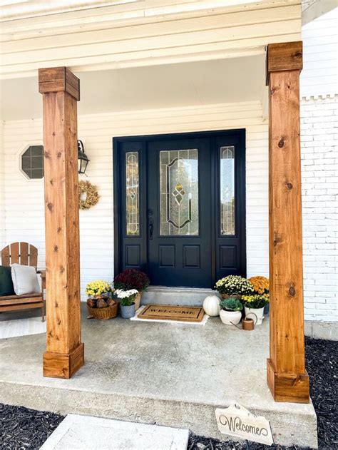 the front porch is decorated with flowers and potted plants