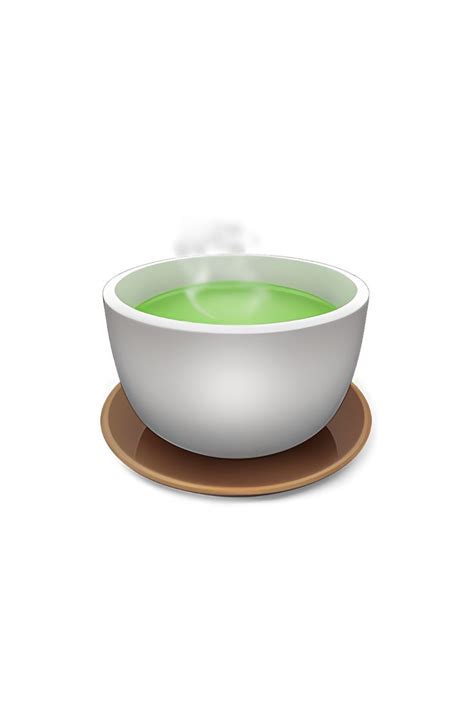 a bowl filled with green liquid sitting on top of a wooden plate