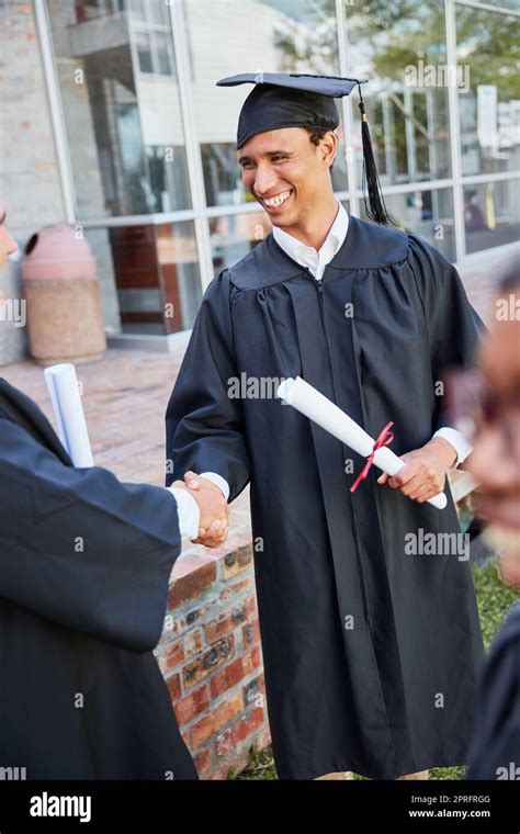 You deserve it. two male students congratulating each other on graduation day Stock Photo - Alamy