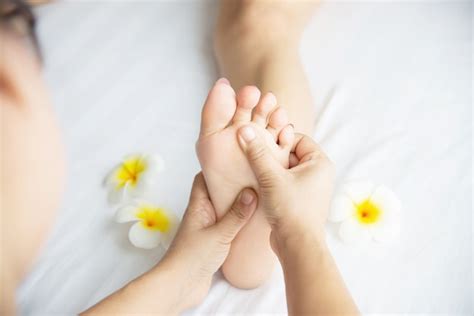 Free Photo | Woman receiving foot massage service from masseuse close up at hand and foot ...