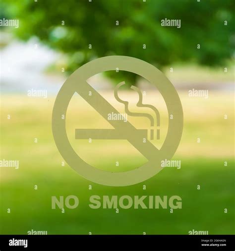 A no smoking sign over a blurred background Stock Photo - Alamy