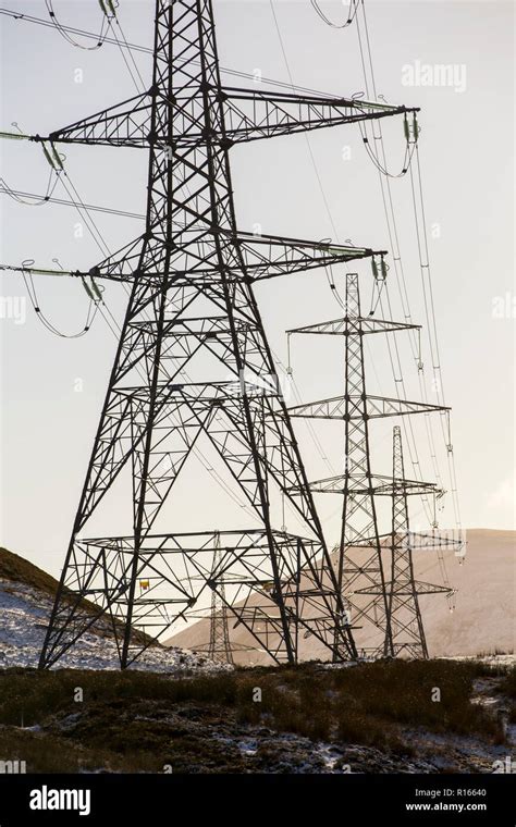 Pylons across the A9 running through mountain scenery, Scotland, UK Stock Photo - Alamy