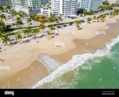 Fort Lauderdale Beach morning after Hurricane Nicole aftermath with cleanup crews removing sand ...